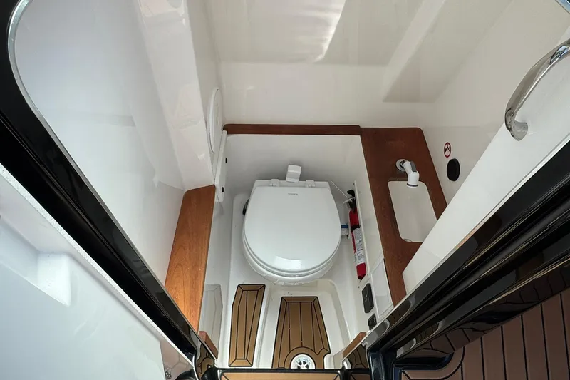 Slide: The Image of 2021 MasterCraft X26 boat interior bathroom with toilet and sink. - 10