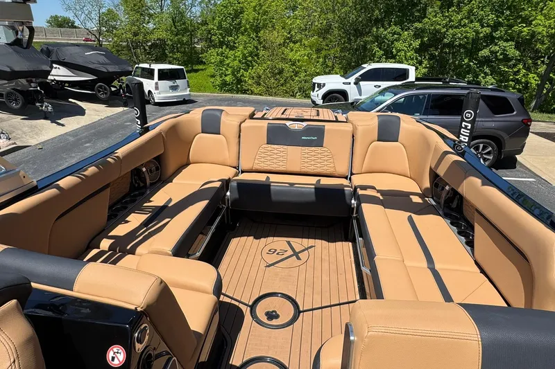 Slide: The Image of Luxurious 2021 MasterCraft X26 boat interior with tan seating and spacious layout. - 11