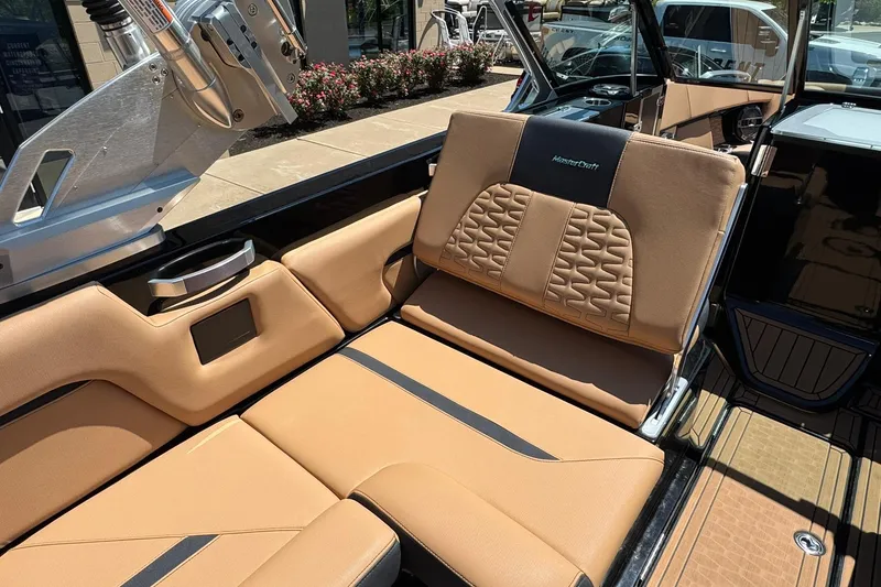 Slide: The Image of 2021 MasterCraft X26 boat interior with tan leather seating and modern design. - 12