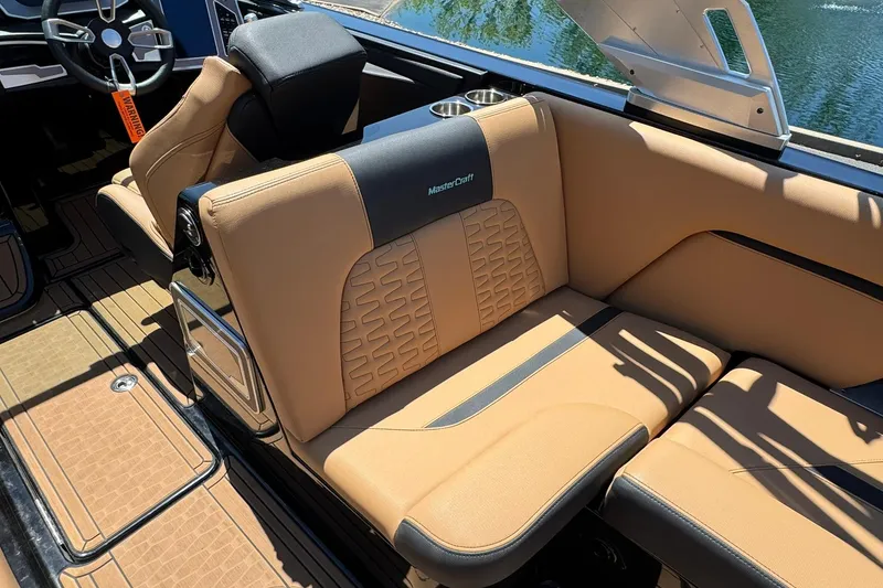 Slide: The Image of 2021 MasterCraft X26 boat interior with tan leather seating and modern design. - 13