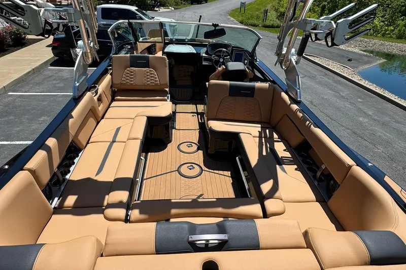 Slide: The Image of 2021 MasterCraft X26 boat interior with tan seating and sleek design. - 14