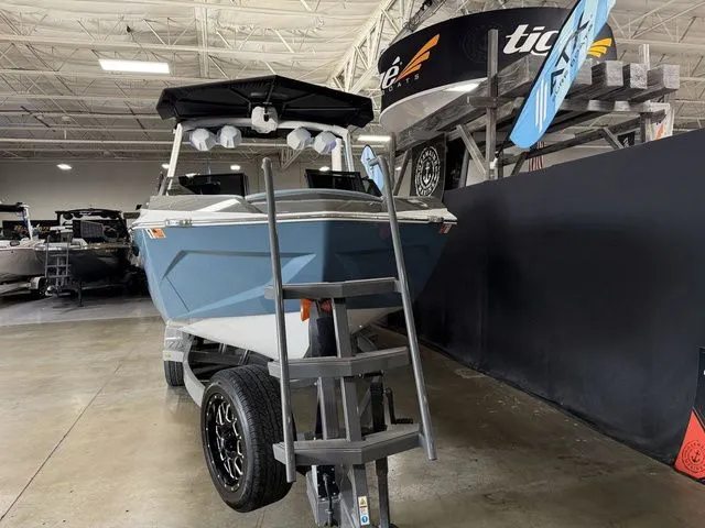 Slide: The Image of 2024 Tigé Ultré 25ZX boat in showroom with ladder. - 3