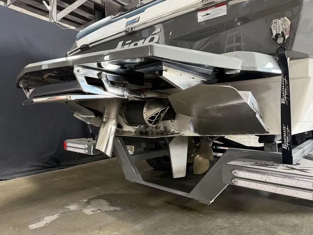 Slide: The Image of Rear view of 2024 Tigé Ultré 25ZX boat in storage. - 5