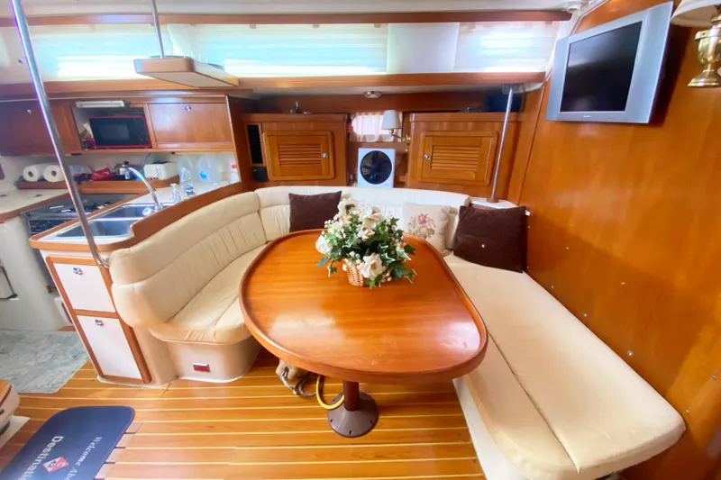 Slide: The Image of Luxurious interior of 2004 Catalina 42 MkII yacht with elegant dining area and modern amenities. - 26