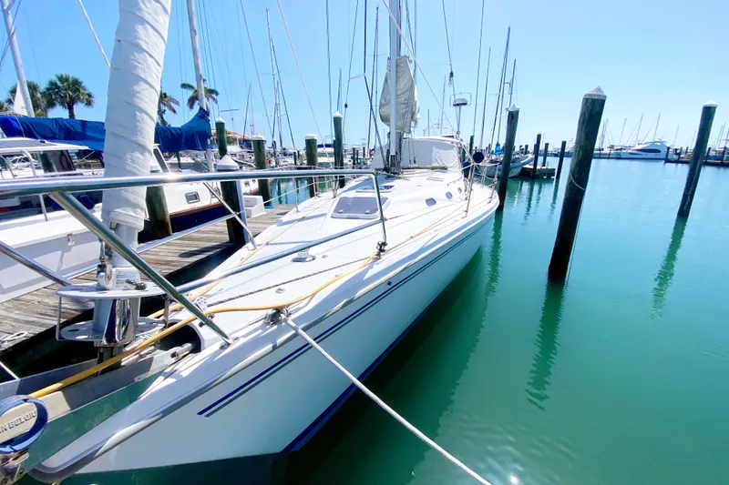 Slide: The Image of 2004 Catalina 42 MkII sailboat docked in a serene marina setting. - 6