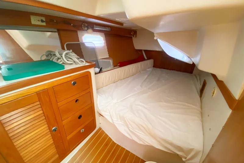 Slide: The Image of Cozy cabin interior of 2004 Catalina 42 MkII sailboat with wooden cabinetry and bed. - 36