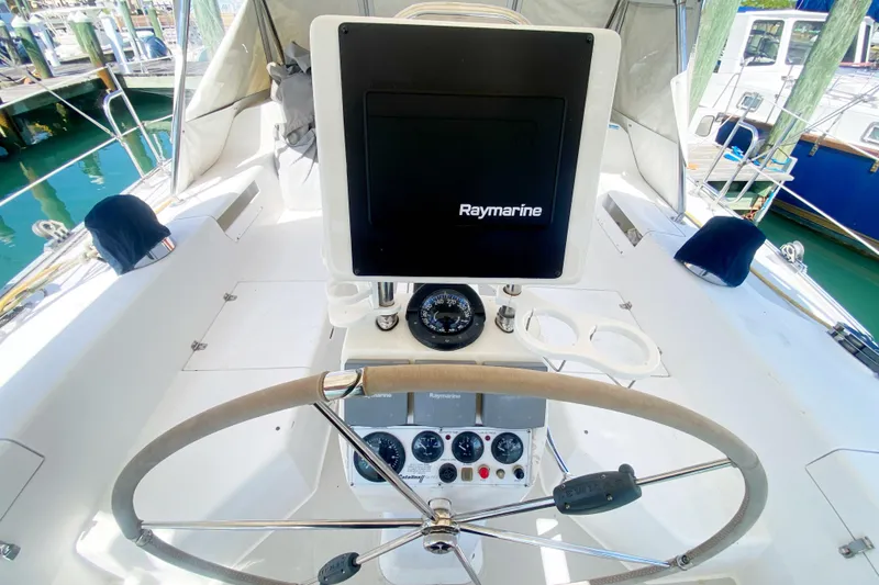 Slide: The Image of Cockpit of 2004 Catalina 42 MkII sailboat with Raymarine navigation system and steering wheel. - 12