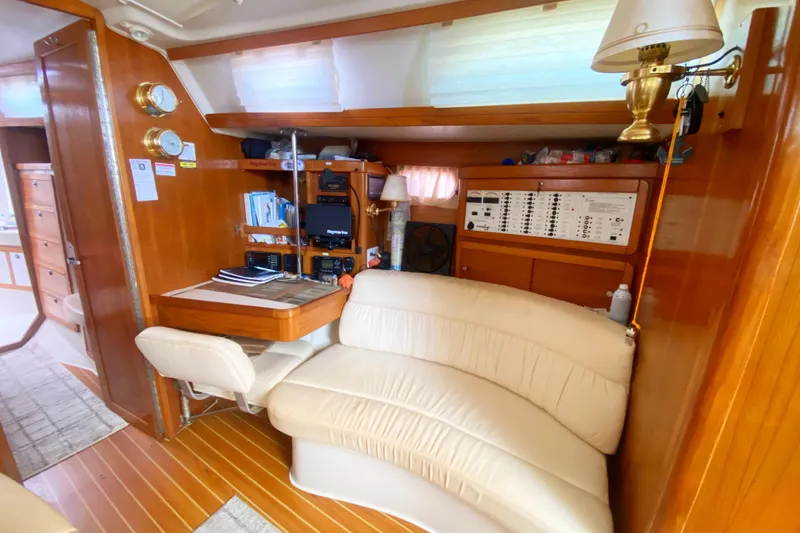 Slide: The Image of Interior of 2004 Catalina 42 MkII yacht with navigation station and cozy seating area. - 27
