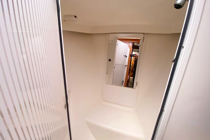 Slide: The Image of Interior of 2004 Catalina 42 MkII sailboat, featuring a compact, modern bathroom space. - 33