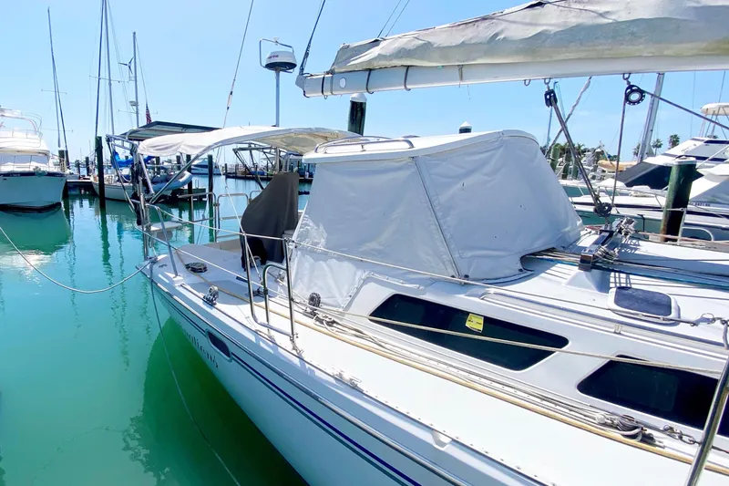 Slide: The Image of 2004 Catalina 42 MkII sailboat docked in a marina under clear blue skies. - 9