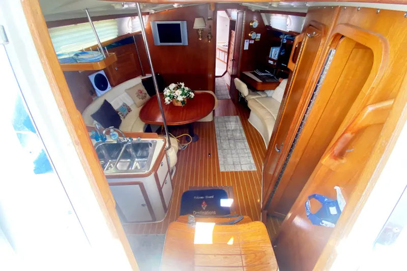 Slide: The Image of Interior of a 2004 Catalina 42 MkII sailboat with wood finish and cozy seating area. - 20