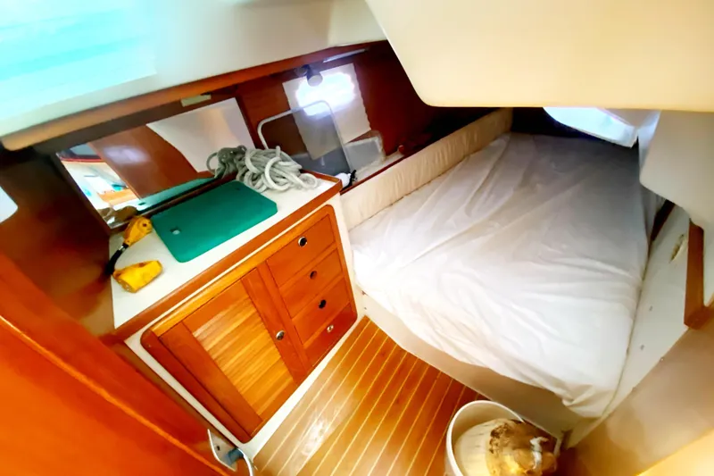 Slide: The Image of Cozy cabin interior of 2004 Catalina 42 MkII sailboat with bed and wooden cabinetry. - 35
