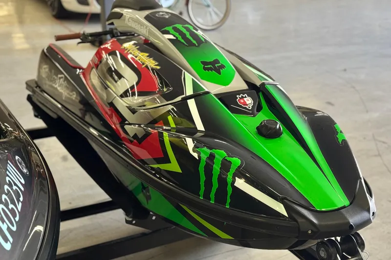 The Image of 2024 Kawasaki Jetski SX-R with vibrant green and black graphics on display. - 0