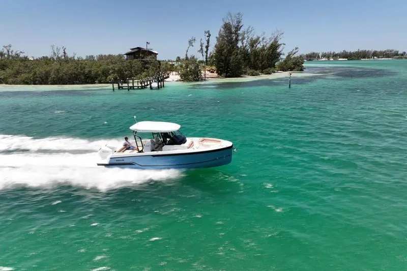 Slide: The Image of Wellcraft 28 T-Top 2026 speeding through turquoise waters. - 3