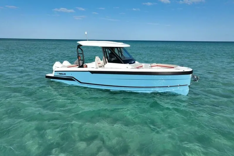 Slide: The Image of 2026 Wellcraft 28 T-Top boat on clear water. - 5