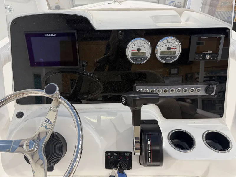 Slide: The Image of Dashboard of a 2019 Tidewater 210 LXF boat with controls and gauges. - 22