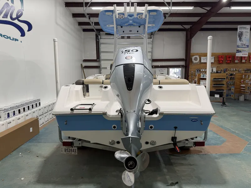 Slide: The Image of Rear view of a 2019 Tidewater 210 LXF boat in a workshop. - 3