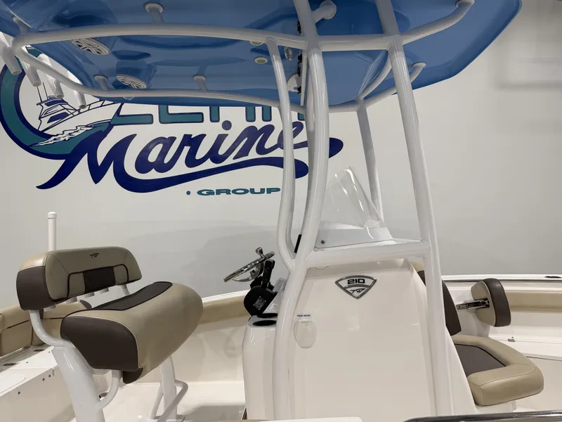 Slide: The Image of 2019 Tidewater 210 LXF boat with blue canopy and seating area. - 7