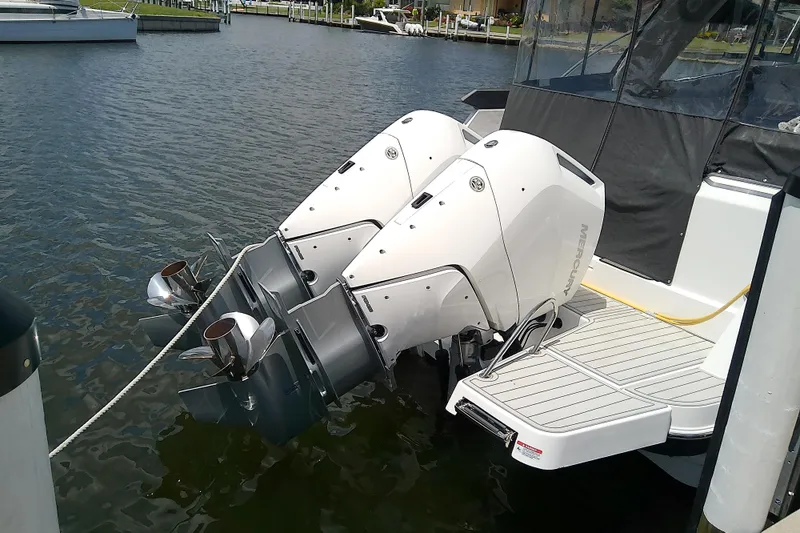 Slide: The Image of 2024 Beneteau Gran Turismo 36 with dual Mercury outboard engines docked on water. - 10