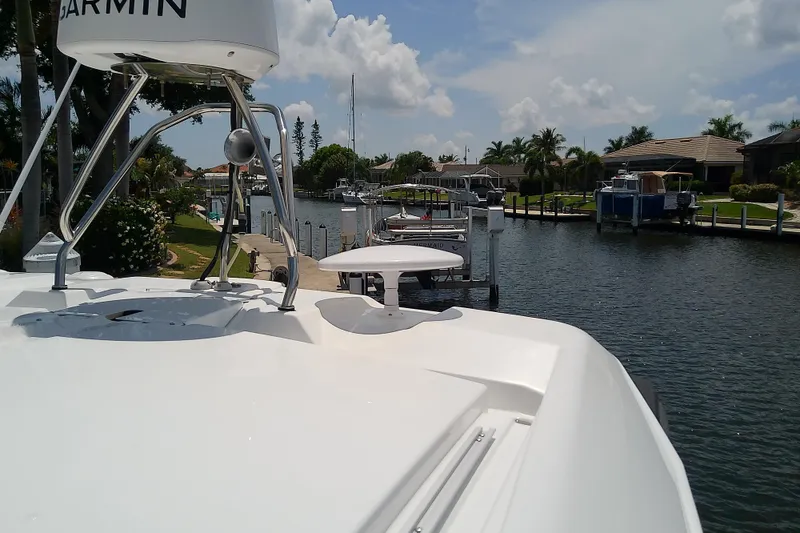 Slide: The Image of 2024 Beneteau Gran Turismo 36 yacht docked in a scenic canal setting. - 13