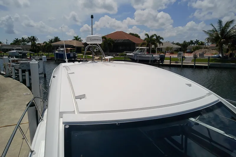Slide: The Image of 2024 Beneteau Gran Turismo 36 yacht docked, showcasing sleek design and Garmin navigation system. - 21