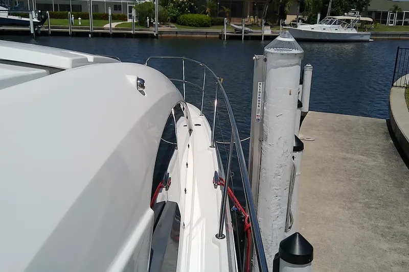 Slide: The Image of 2024 Beneteau Gran Turismo 36 yacht docked at marina, side view. - 22