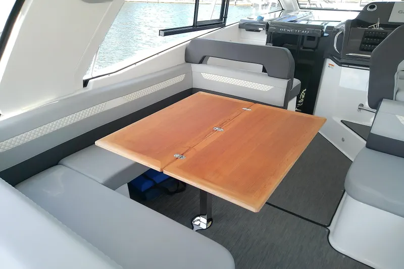 Slide: The Image of Interior of 2024 Beneteau Gran Turismo 36, featuring a sleek dining area with wooden table. - 28