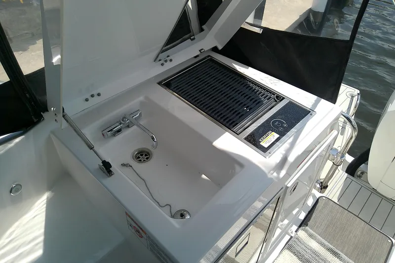 Slide: The Image of 2024 Beneteau Gran Turismo 36 yacht with outdoor sink and grill setup. - 32
