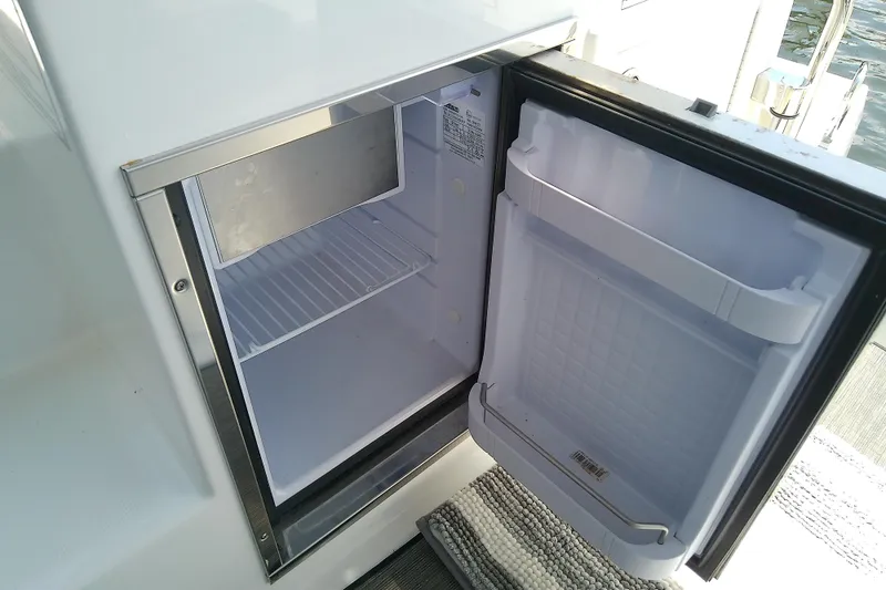 Slide: The Image of Open refrigerator on 2024 Beneteau Gran Turismo 36 yacht, showcasing interior storage space. - 35