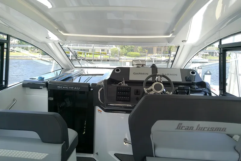 Slide: The Image of 2024 Beneteau Gran Turismo 36 cockpit with Garmin navigation, sleek design, and waterfront view. - 37