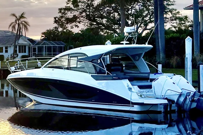 Slide: The Image of 2024 Beneteau Gran Turismo 36 yacht docked at sunset, showcasing sleek design and modern features. - 4