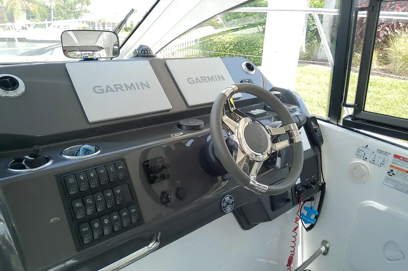 Slide: The Image of 2024 Beneteau Gran Turismo 36 helm with Garmin navigation displays and modern controls. - 42