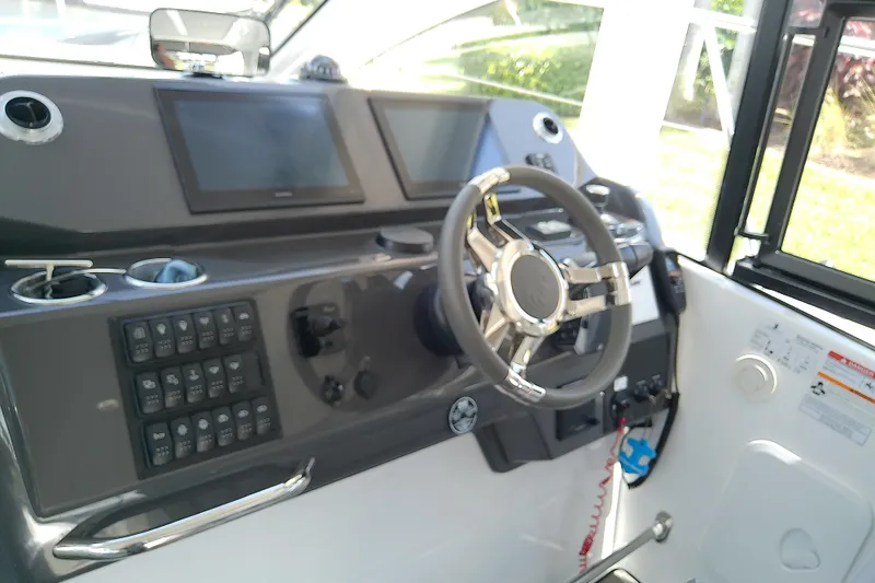 Slide: The Image of 2024 Beneteau Gran Turismo 36 helm with modern controls and dual displays. - 43