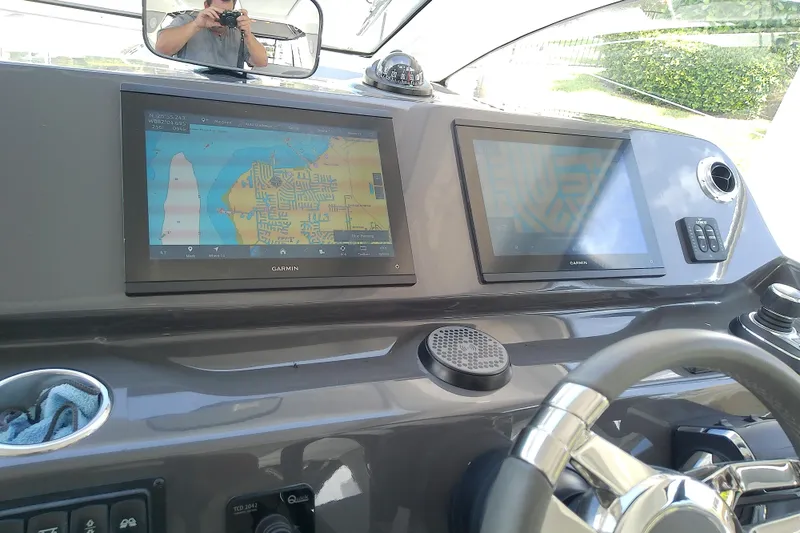 Slide: The Image of 2024 Beneteau Gran Turismo 36 dashboard with Garmin navigation displays and steering wheel. - 44