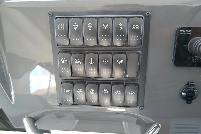 Slide: The Image of Control panel of 2024 Beneteau Gran Turismo 36 with labeled switches and thruster control. - 47