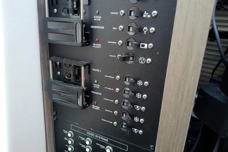 Slide: The Image of Control panel of a 2024 Beneteau Gran Turismo 36 yacht, featuring various switches and indicators. - 62