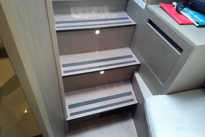 Slide: The Image of Interior stairs of 2024 Beneteau Gran Turismo 36 yacht, featuring modern design and lighting. - 65