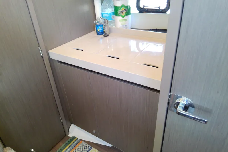Slide: The Image of 2024 Beneteau Gran Turismo 36 bathroom sink area with modern fixtures and storage. - 67