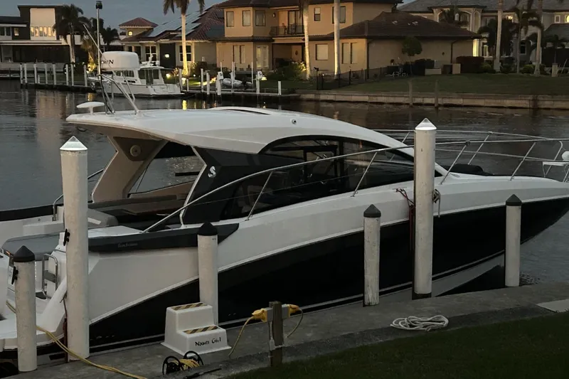 Slide: The Image of 2024 Beneteau Gran Turismo 36 yacht docked at a marina during sunset. - 7