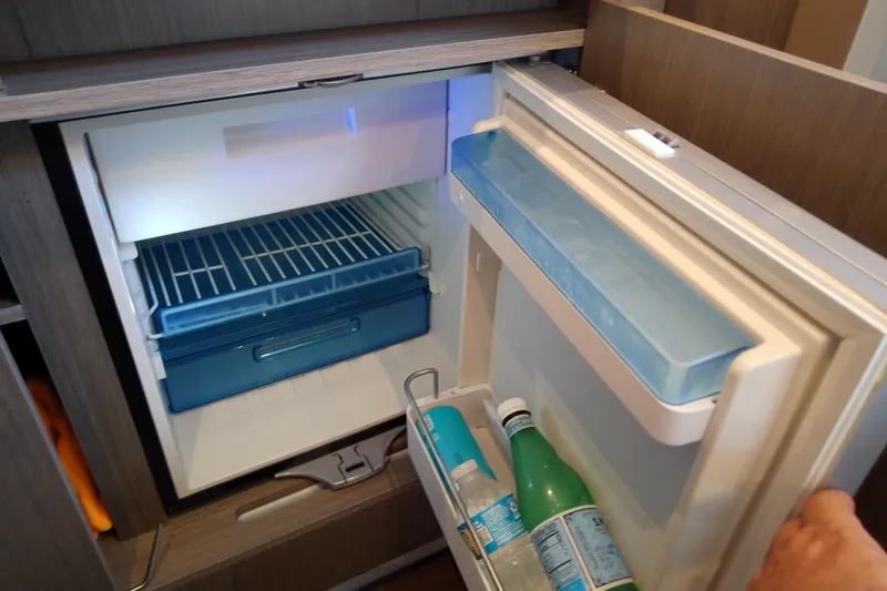 Slide: The Image of Compact refrigerator inside 2024 Beneteau Gran Turismo 36 yacht, stocked with beverages. - 72