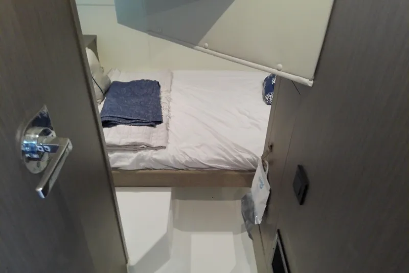 Slide: The Image of Cozy cabin interior of 2024 Beneteau Gran Turismo 36 yacht with neatly made bed. - 74
