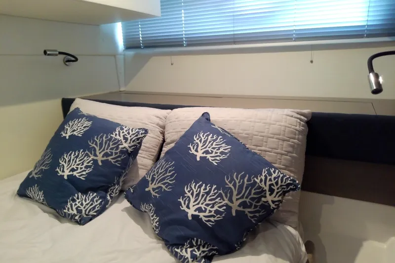 Slide: The Image of Interior cabin of 2024 Beneteau Gran Turismo 36 with decorative pillows and modern lighting. - 75