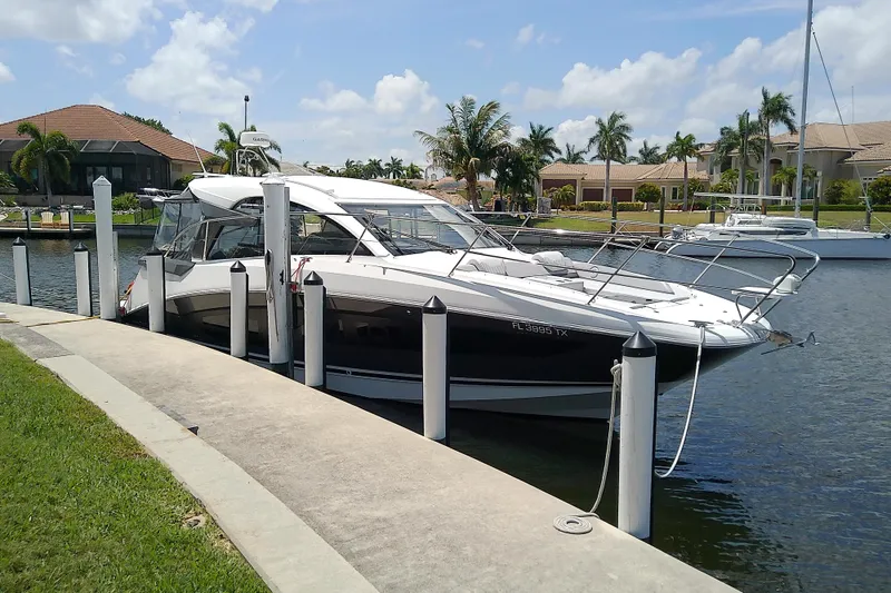 Slide: The Image of 2024 Beneteau Gran Turismo 36 yacht docked in a sunny marina setting. - 8