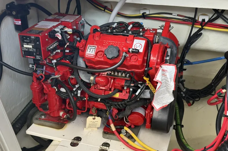 Slide: The Image of Engine compartment of 2024 Beneteau Gran Turismo 36, featuring a red multiport EFI engine. - 86