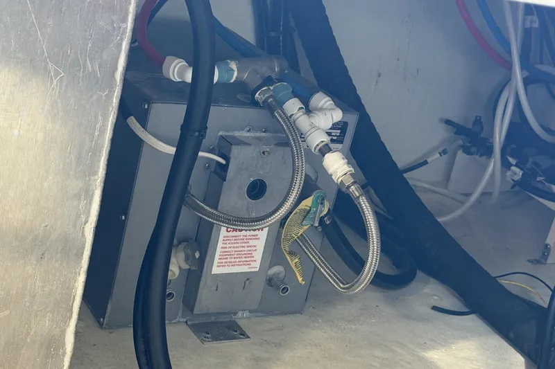 Slide: The Image of Engine compartment of 2024 Beneteau Gran Turismo 36 with visible wiring and components. - 90