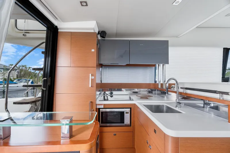 Slide: The Image of Modern kitchen interior on a 2016 Prestige 500 yacht, featuring sleek cabinetry and appliances. - 12