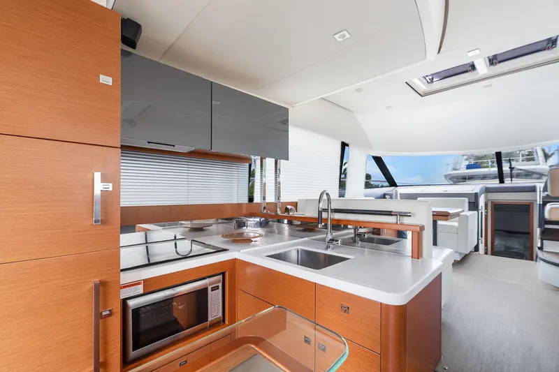 Slide: The Image of Luxurious interior of a 2016 Prestige 500 yacht featuring a modern kitchen and seating area. - 13