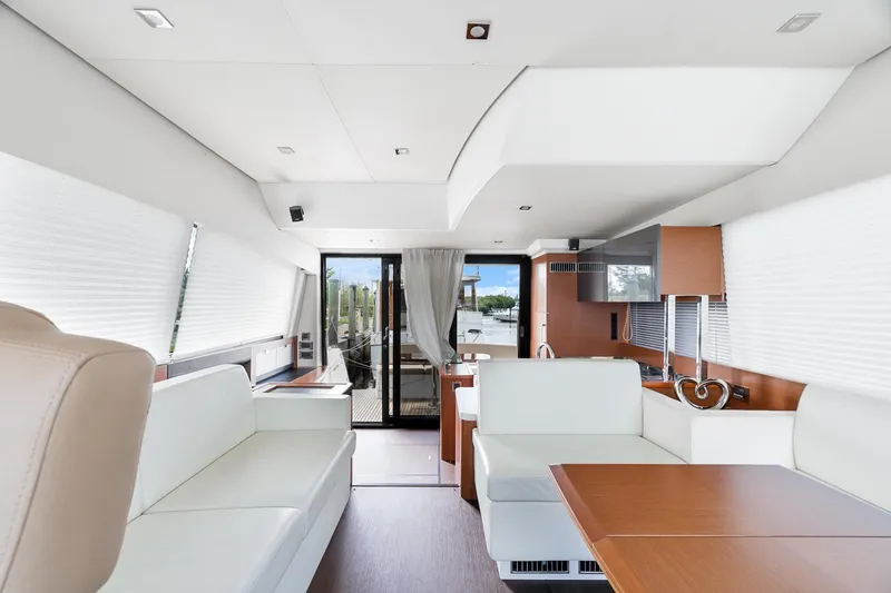 Slide: The Image of Luxurious interior of a 2016 Prestige 500 yacht with modern furnishings and ample natural light. - 16