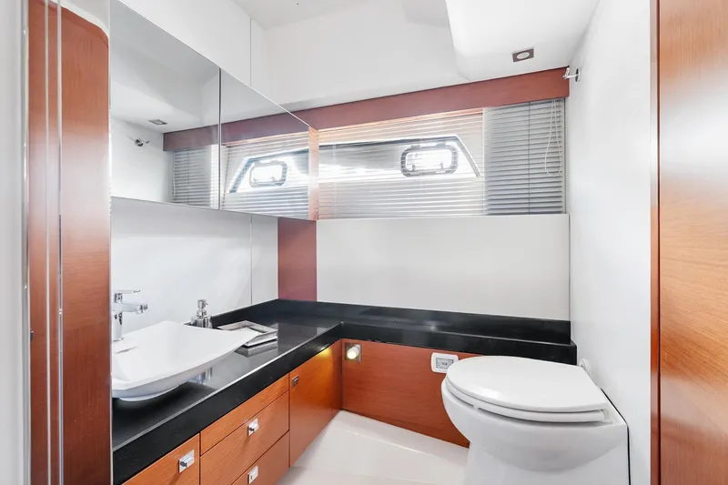 Slide: The Image of Luxurious 2016 Prestige 500 yacht bathroom with modern fixtures and sleek wood accents. - 26