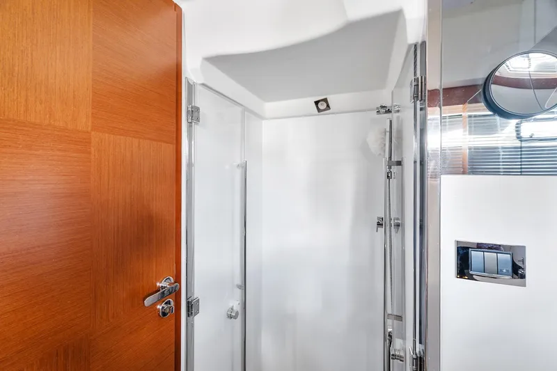 Slide: The Image of Modern shower area in 2016 Prestige 500 yacht, featuring sleek design and wooden accents. - 27